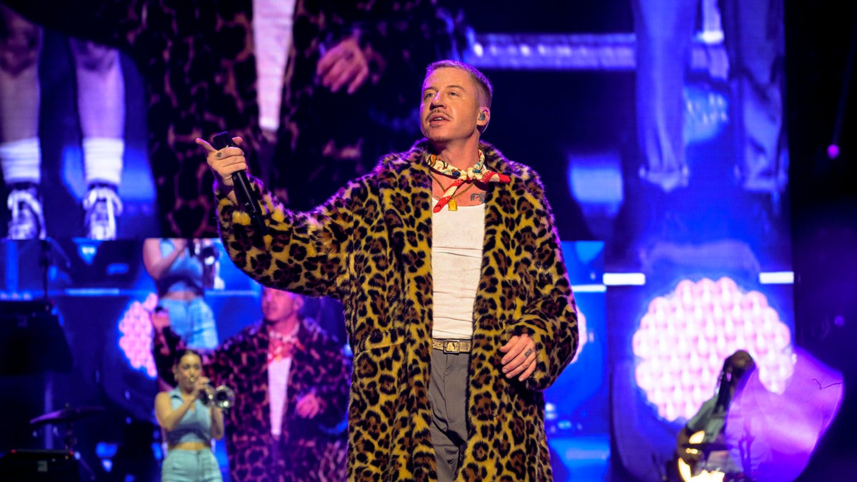 Macklemore appears in a faux fur coat