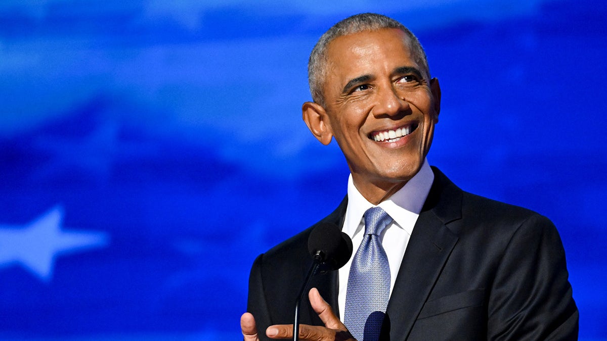 Obama smiles connected  DNC stage