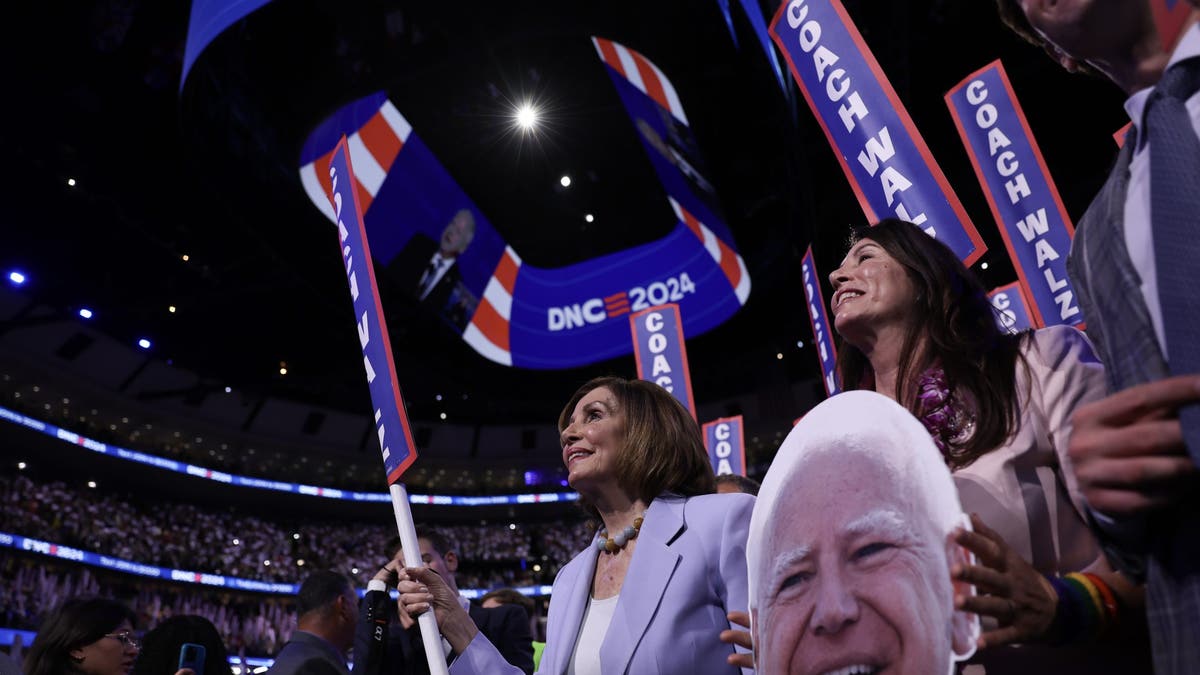 Former House Speaker Rep. Nancy holds a sign that says 