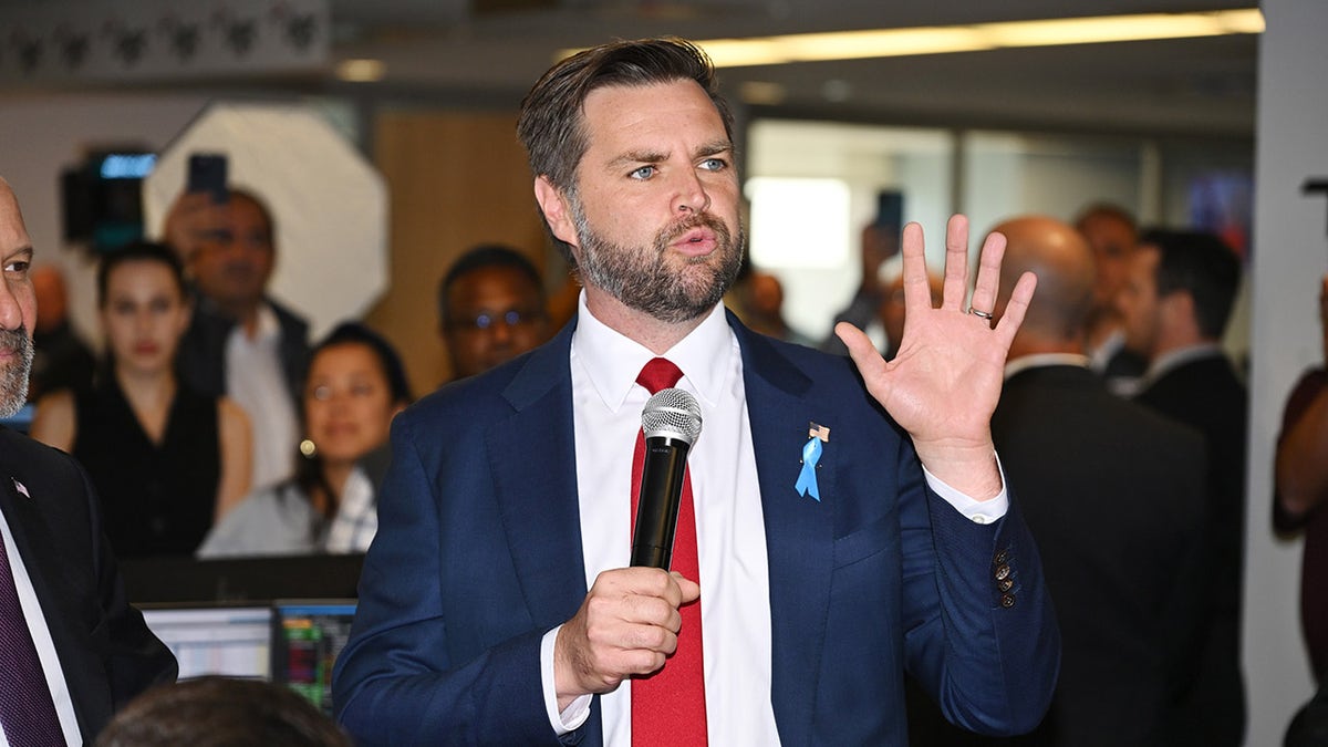 Close-up of JD Vance, holding microphone