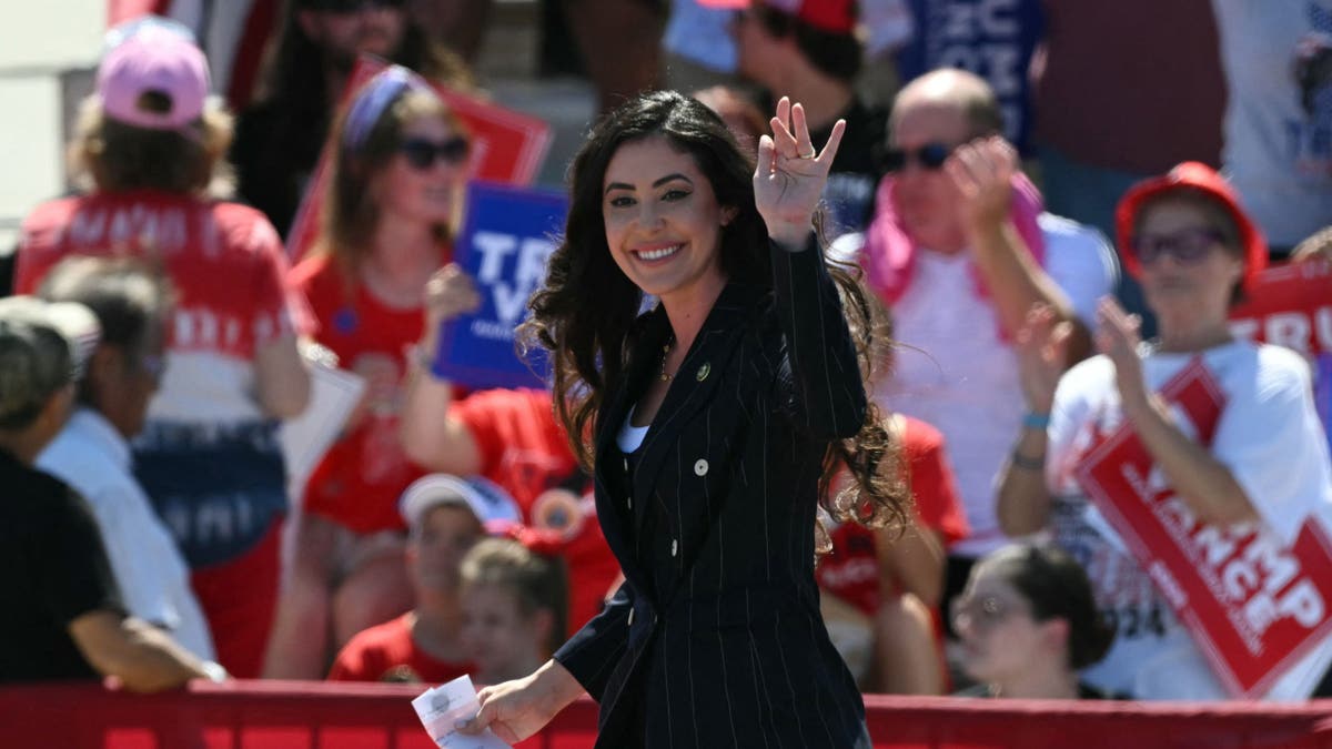 Luna waves at a Trump campaign rally 