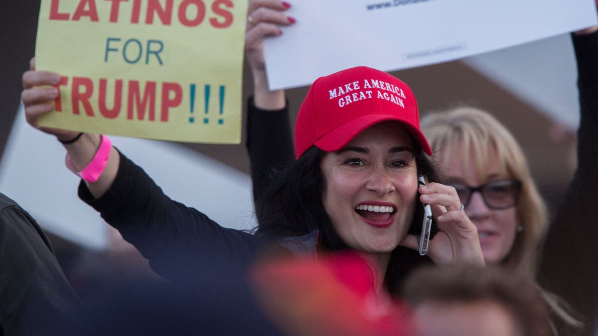 A woman holds a sign expressing support for former President Trump at his campaign rally at the Orange County Fair and Event Center, April 28, 2016, in Costa Mesa, California. (David McNew/AFP via Getty Images)