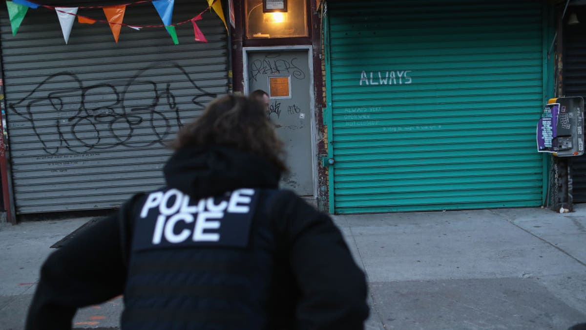 U.S. Immigration and Customs Enforcement officers look to arrest an undocumented immigrant during an operation in the Bushwick neighborhood of Brooklyn on April 11, 2018, in New York City.