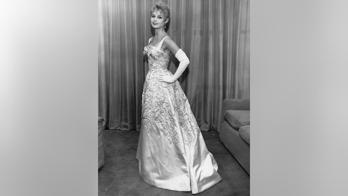 Brigitte Bardot posing in a glamorous gown.