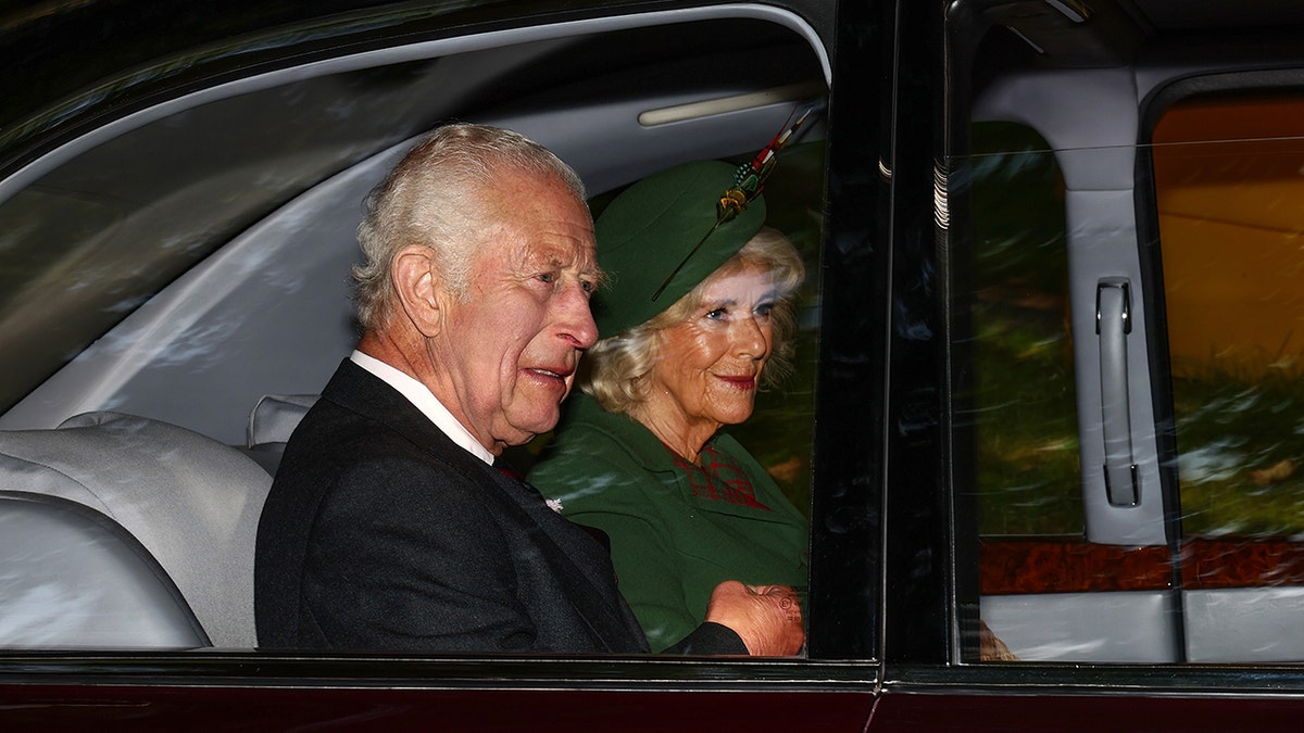 King Charles in a car with Queen Camilla.