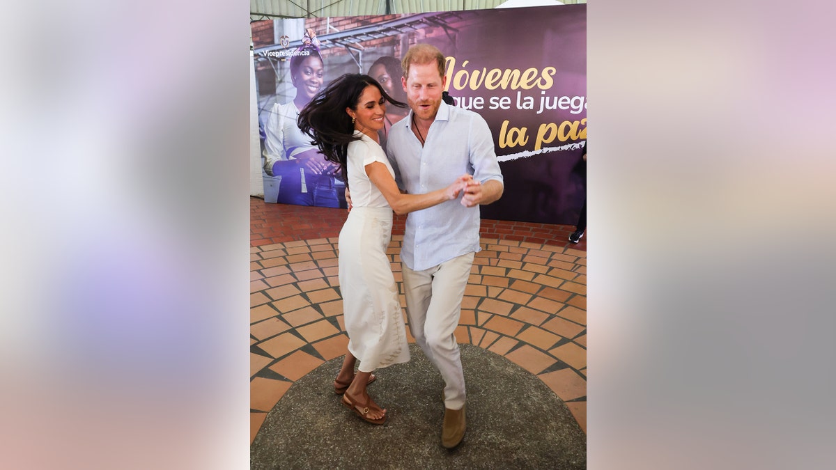 Prince Harry and Meghan Markle dancing.