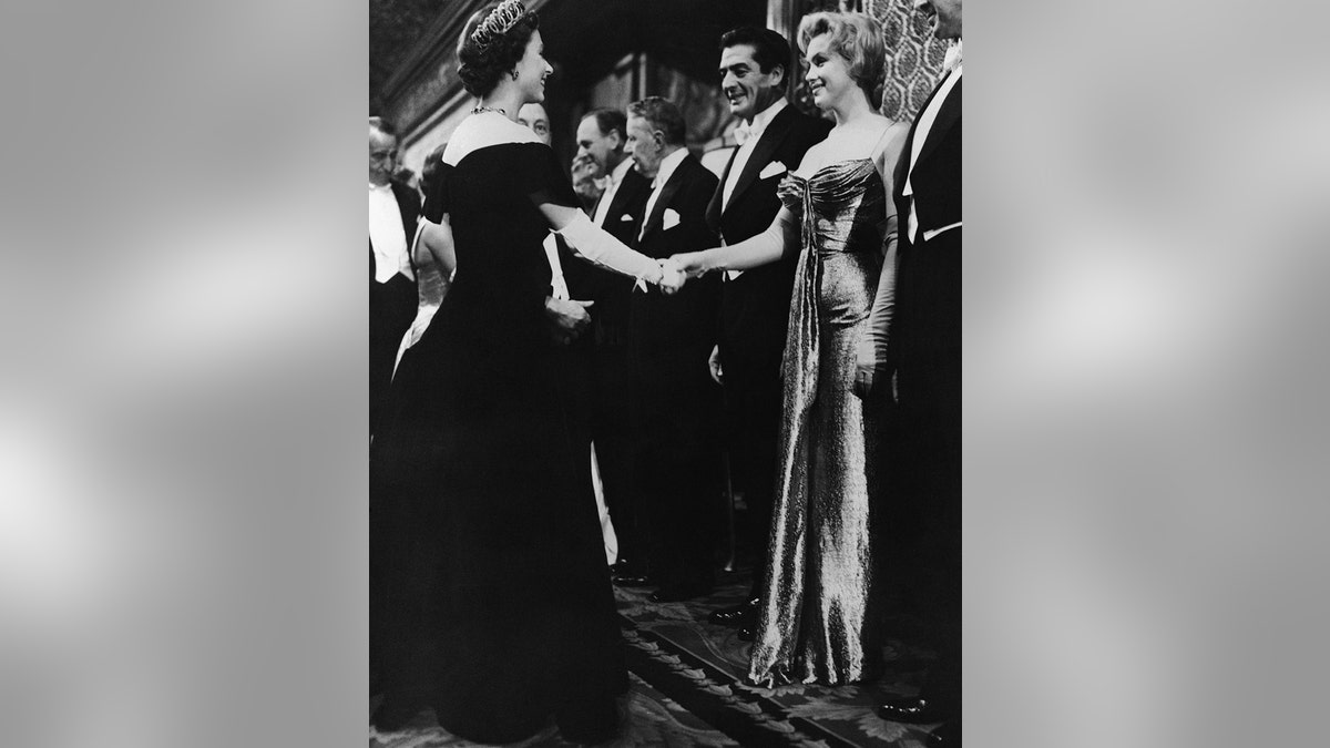 Queen Elizabeth shaking Marilyn Monroes hand.