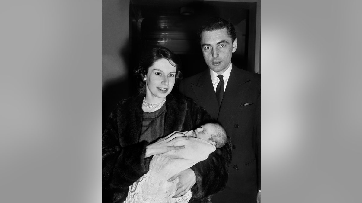 Virginia Ogilvy holding her baby next to her husband David