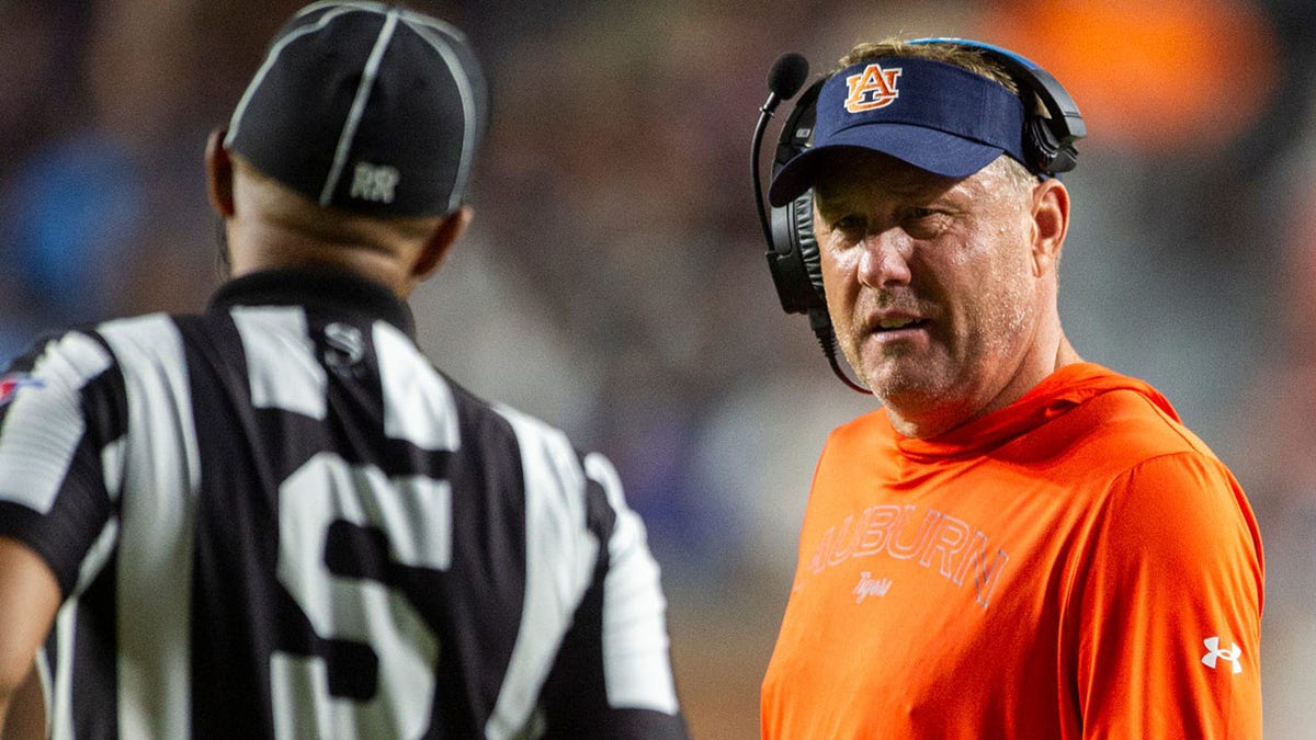 Hugh Freeze habla con los funcionarios