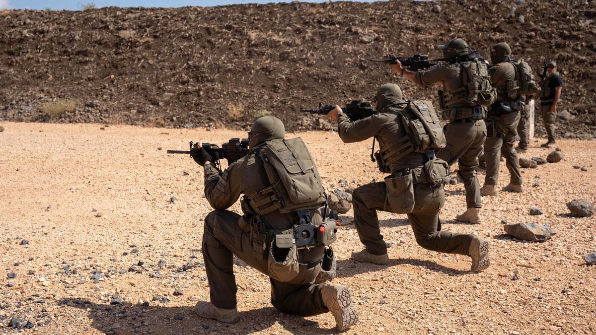 Soldiers firing weapons