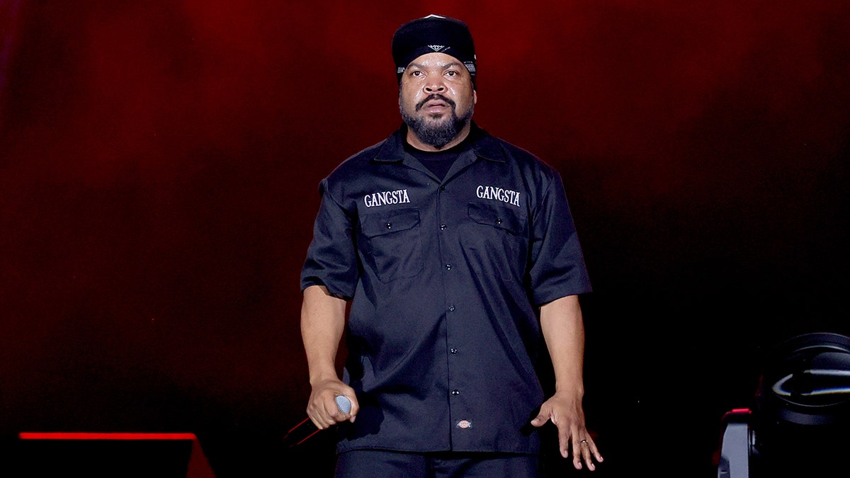 Ice Cube lasting  connected  signifier    with a microphone