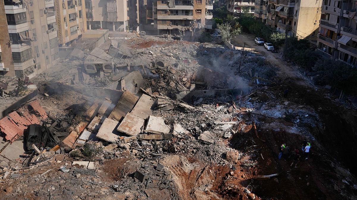 People gather near the site of the assassination of Hezbollah leader Hassan Nasrallah in the southern suburbs of Beirut