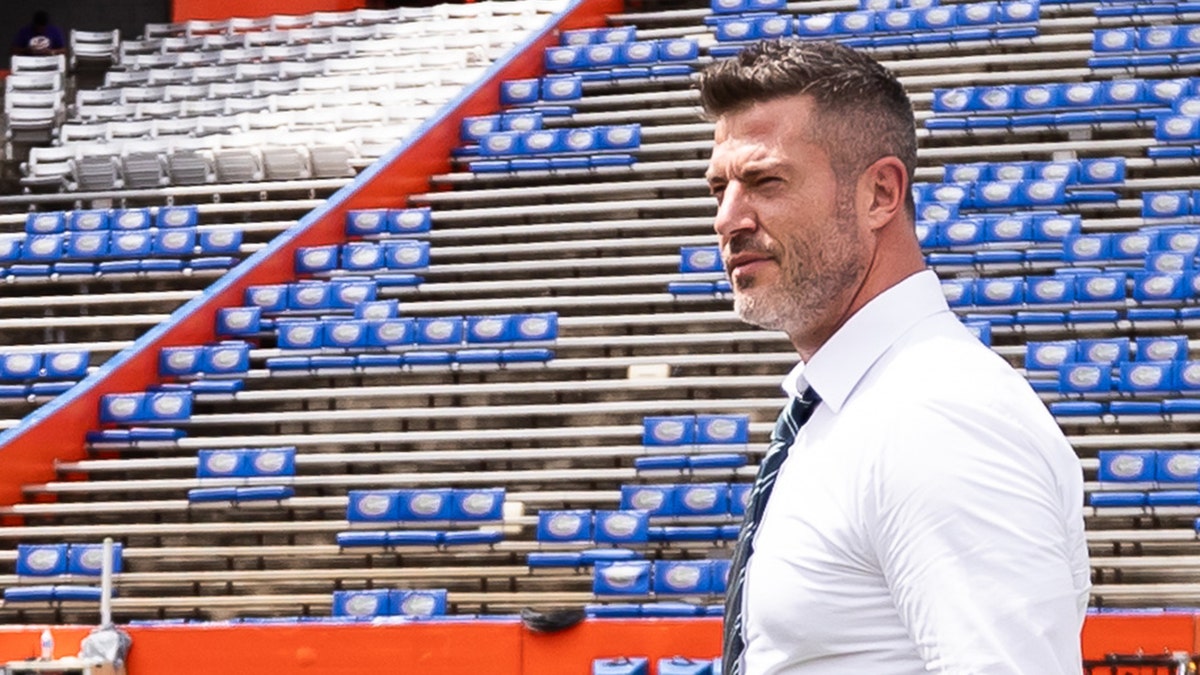 Jesse Palmer walks across the field