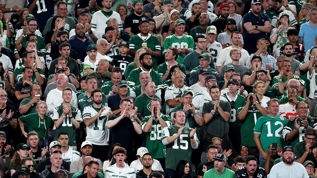 Los aficionados de los Jets animan en las gradas