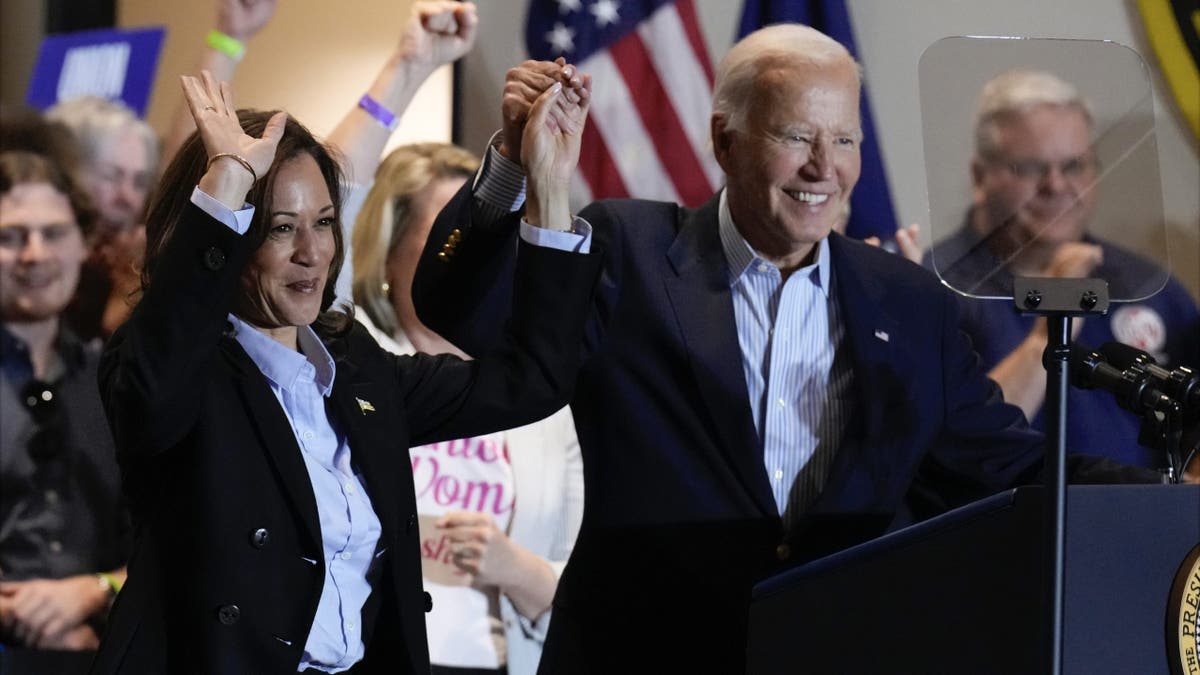 Biden and Harris raise their arms during campaign event