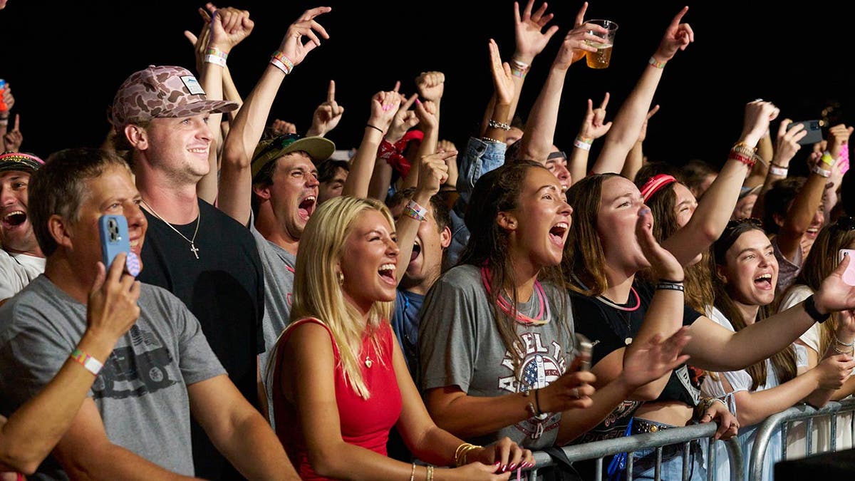 The crowd cheers for John Rich at his concert