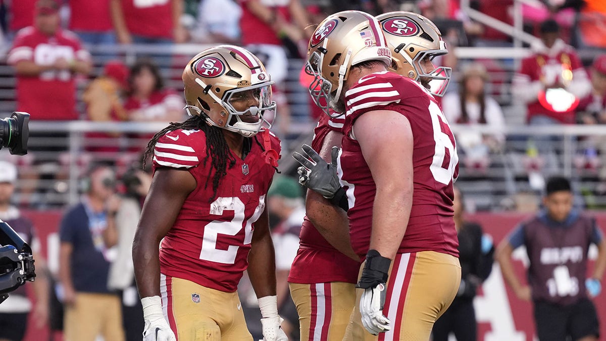 Jordan Mason celebrates a touchdown