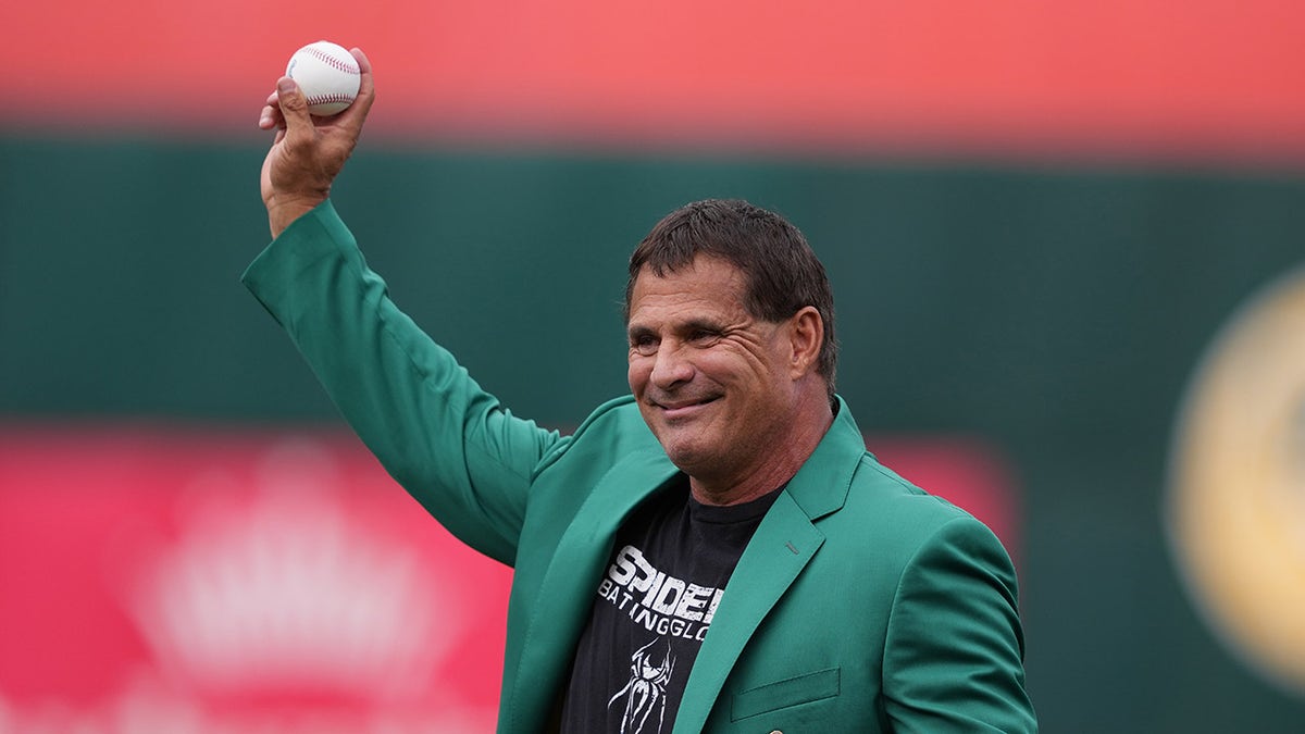 Jose Canseco throws the first pitch