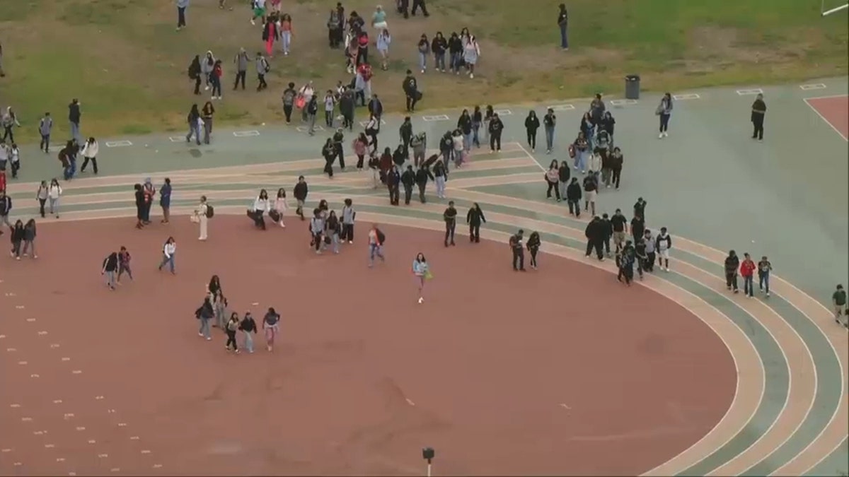 Students are seen outside after an earthquake shook Los Angeles