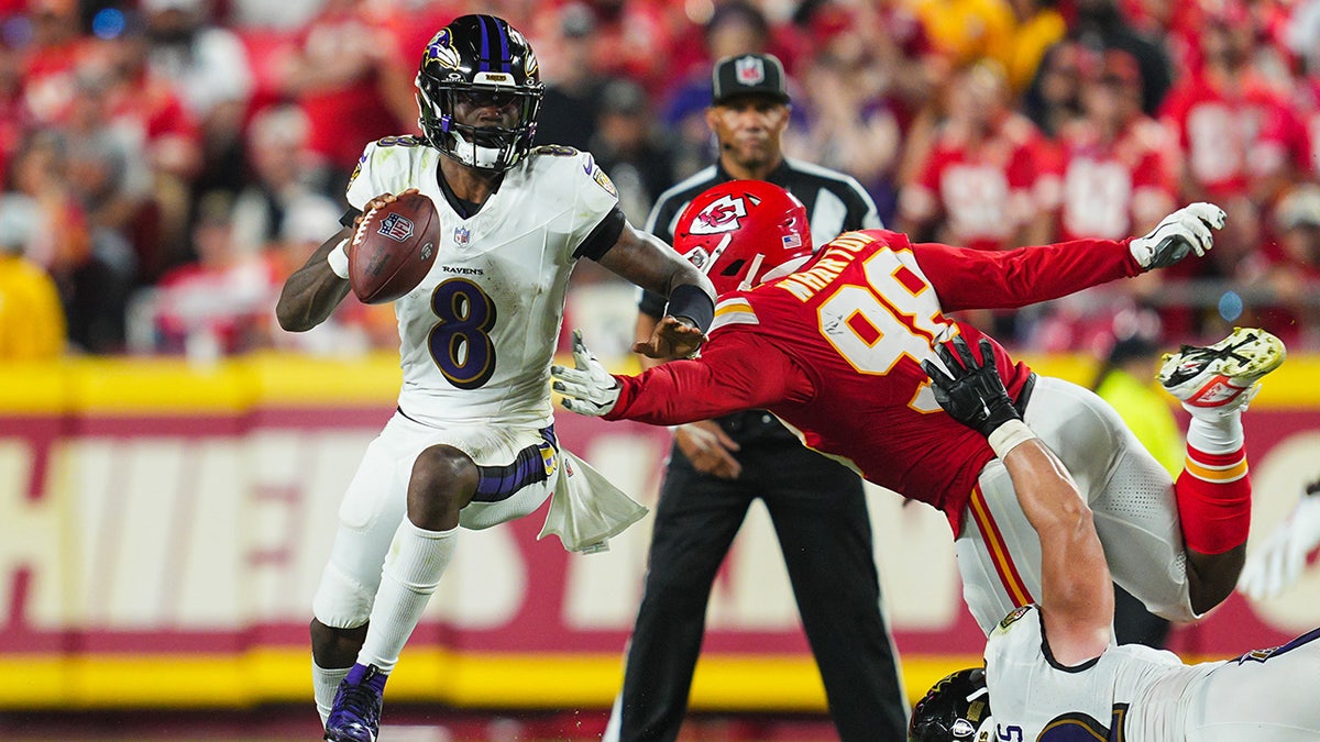 Lamar Jackson runs onto the field