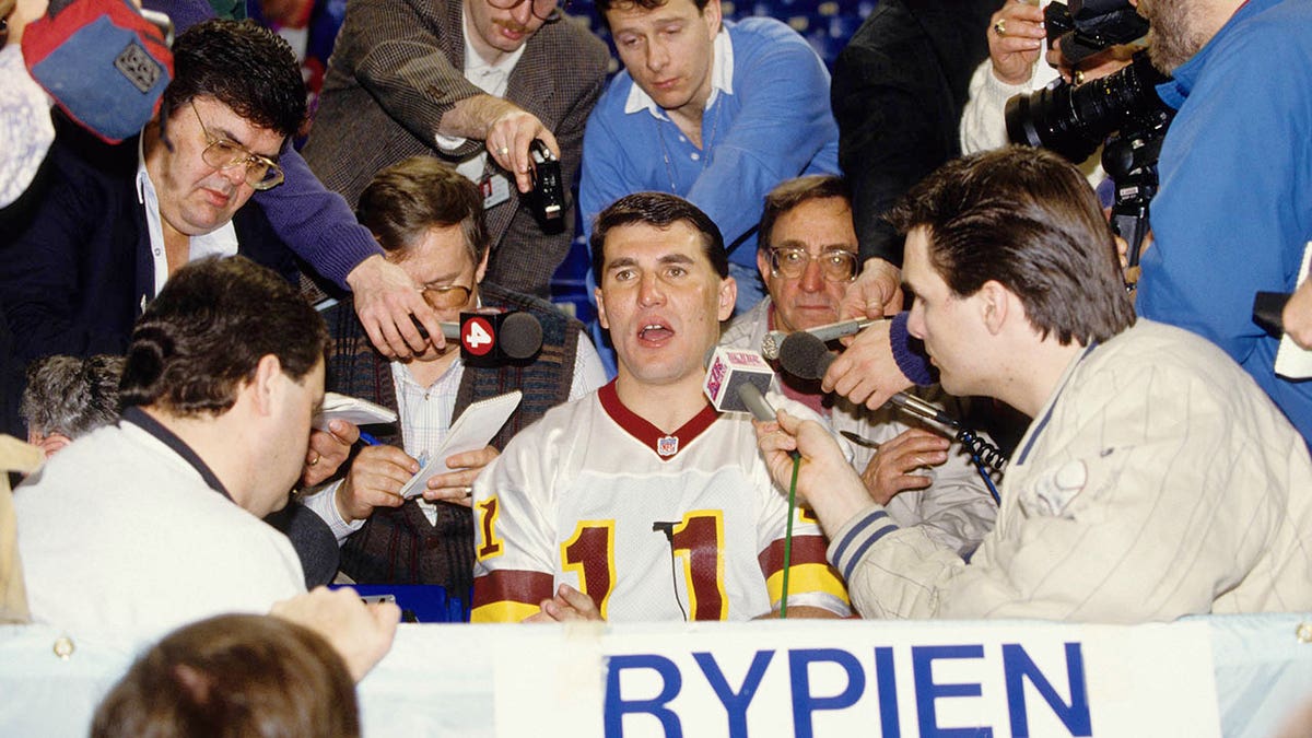 Mark Rypien talks to reporters