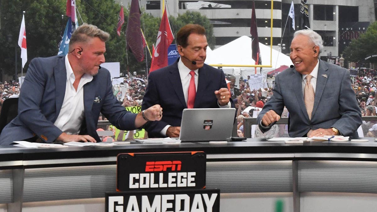 Pat McAfee, Nick Saban, and Lee Corso fist bump