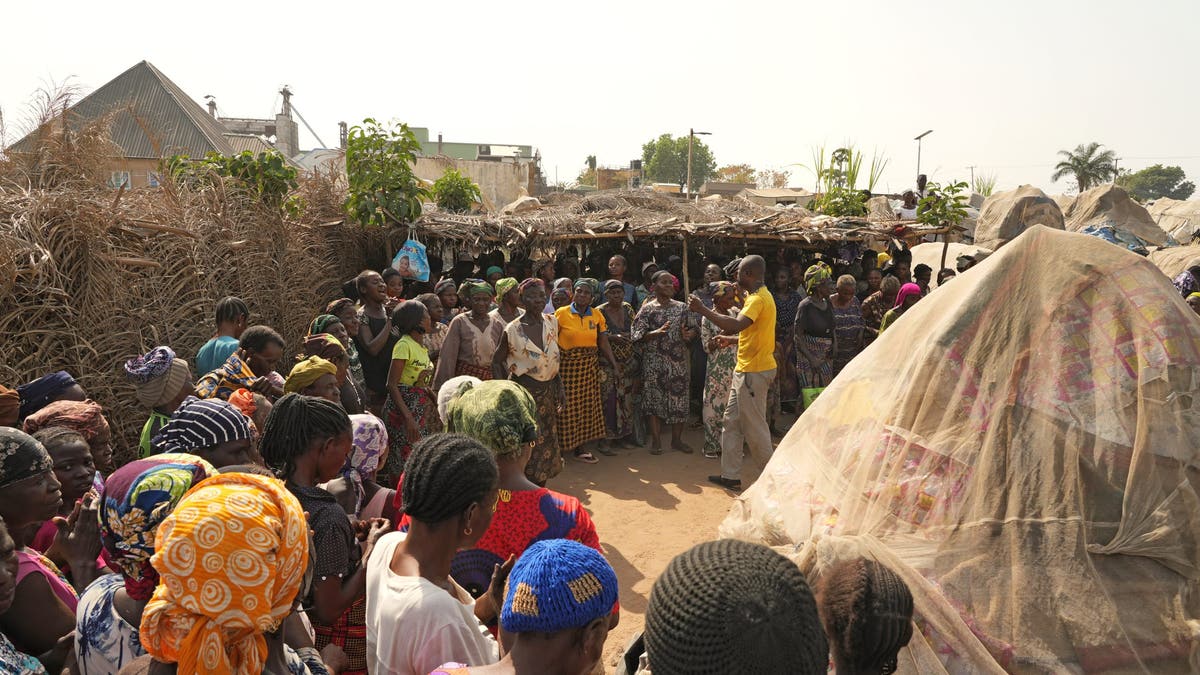 Pastor Benjamin Barnabas leads a service of Christian IDP's in a Nigerian refugee camp. 