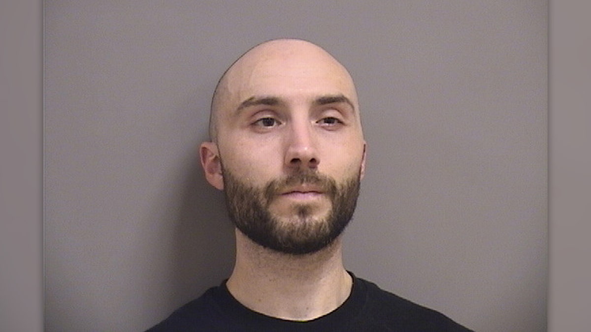 Nicholas Carter has a bald head and short brown beard in mugshot