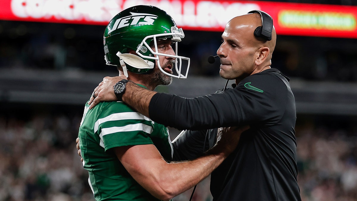 Aaron Rodgers and Robert Saleh hug