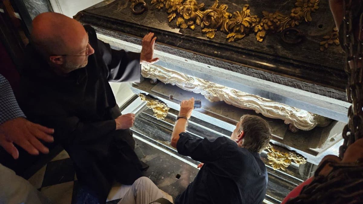 Researchers observing tomb