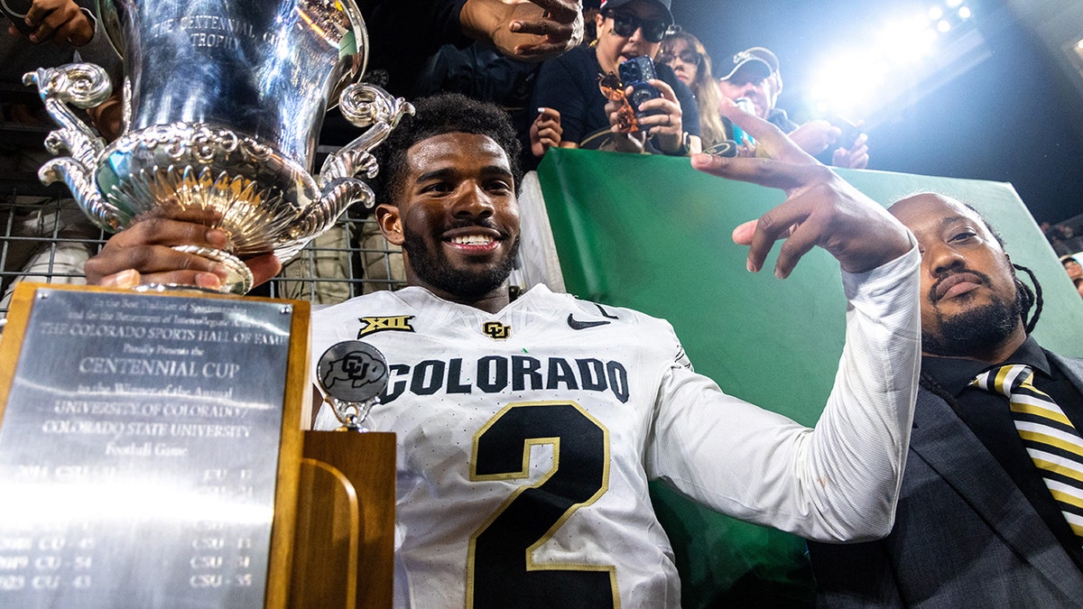 Shedeur Sanders poses with the trophy