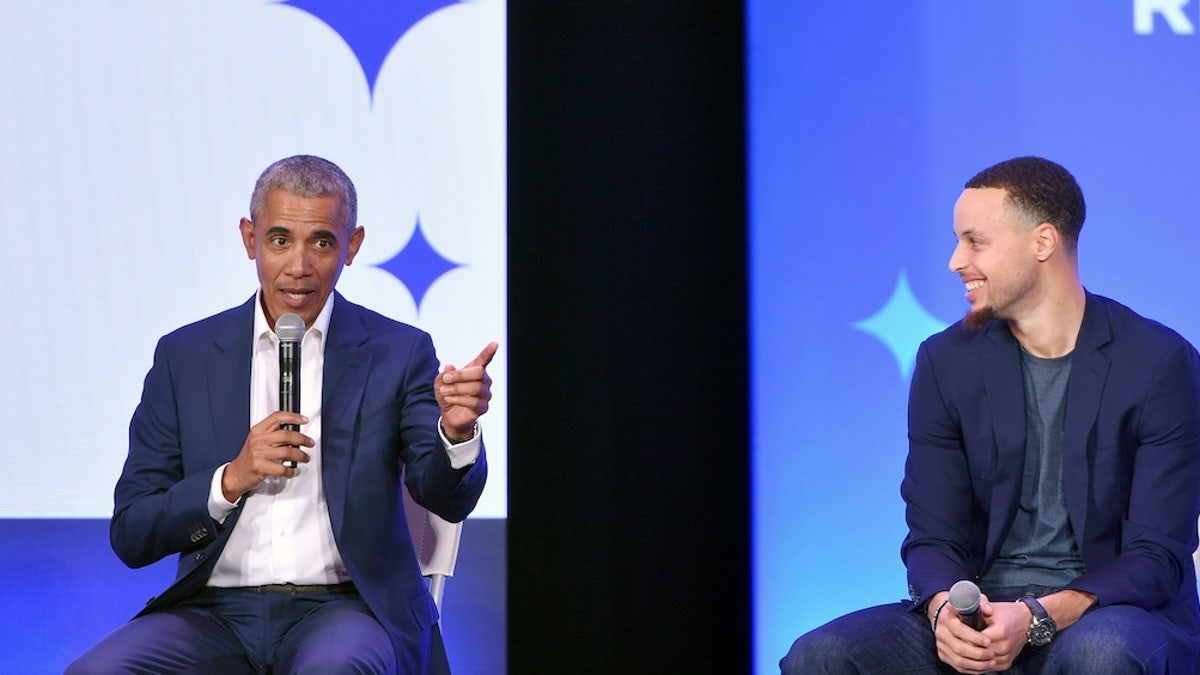 Former President Barack Obama speaks alongside Golden State Warriors basketball player Stephen Curry.