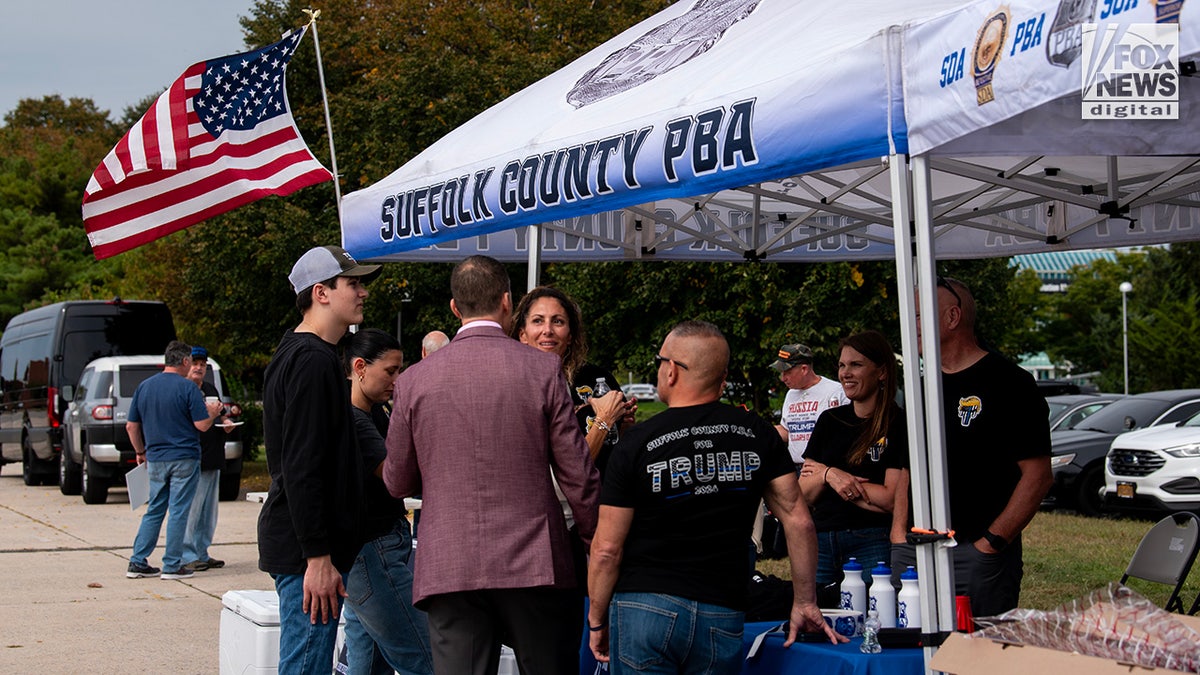 Members of the Suffolk County PBA attend a tailgate party before former President Donald Trump's rally in Uniondale, New York