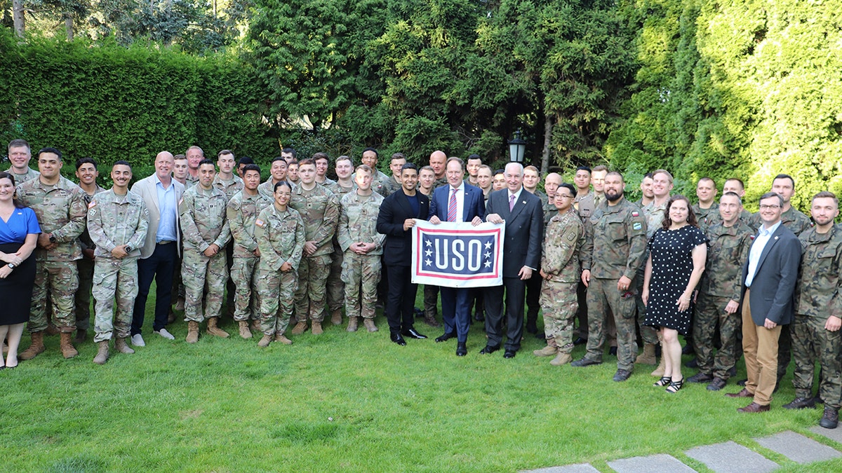 Wilmer Valderrama surrounded by a group of soldiers