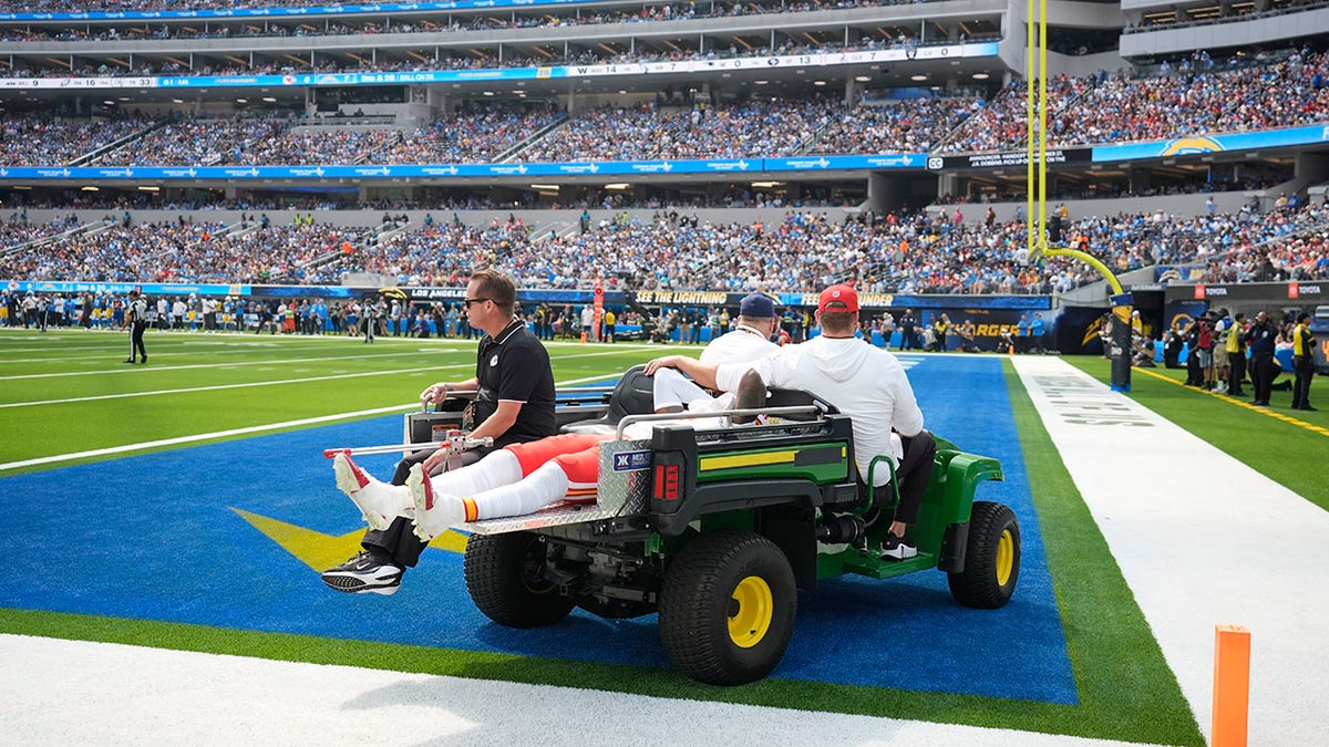 Rashee Rice is taken off the field on a cart