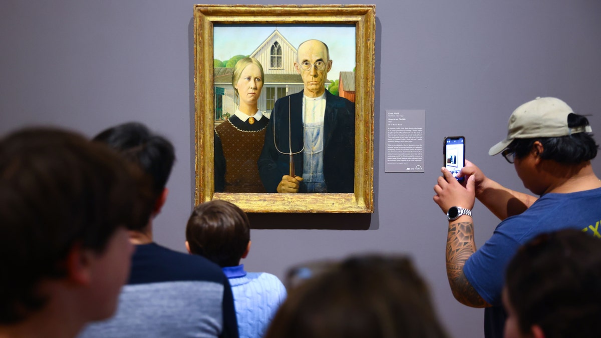 ‘American Gothic’, famous piece by artist Grant Wood, is displayed to visitors at the Art Institute of Chicago  at george magazine