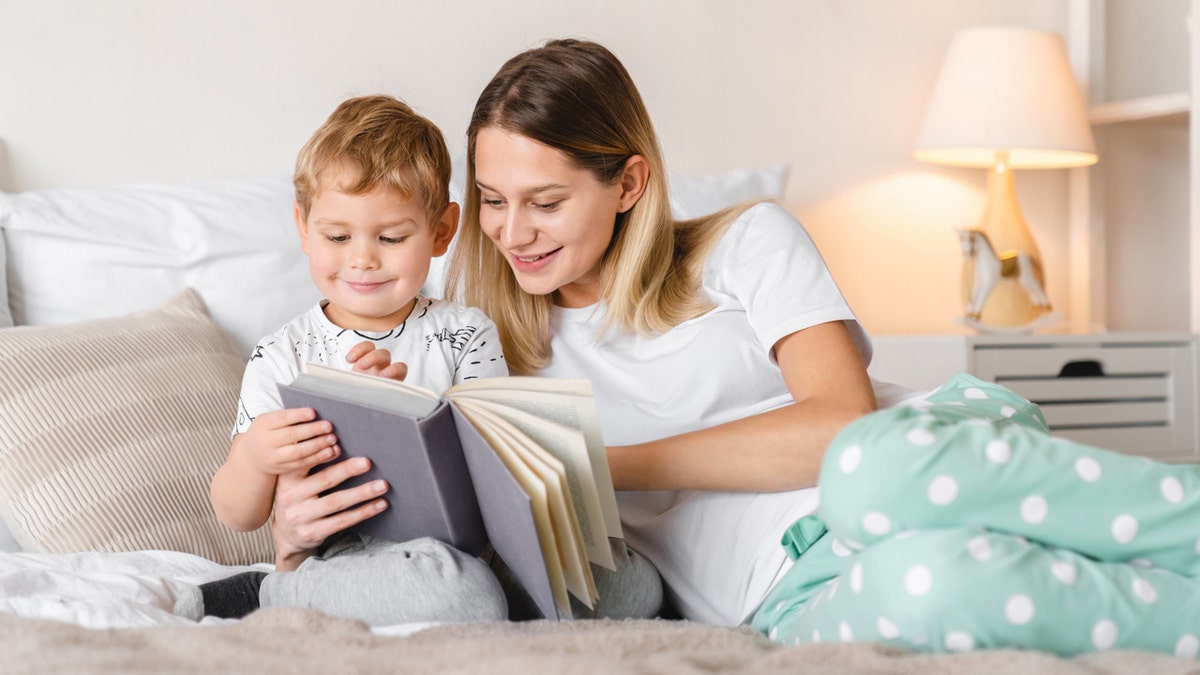 Mamá e hijo pequeño leyendo juntos un libro