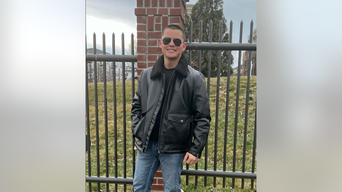 Collin Gosselin in a black jacket and jeans wearing black sunglasses smiling