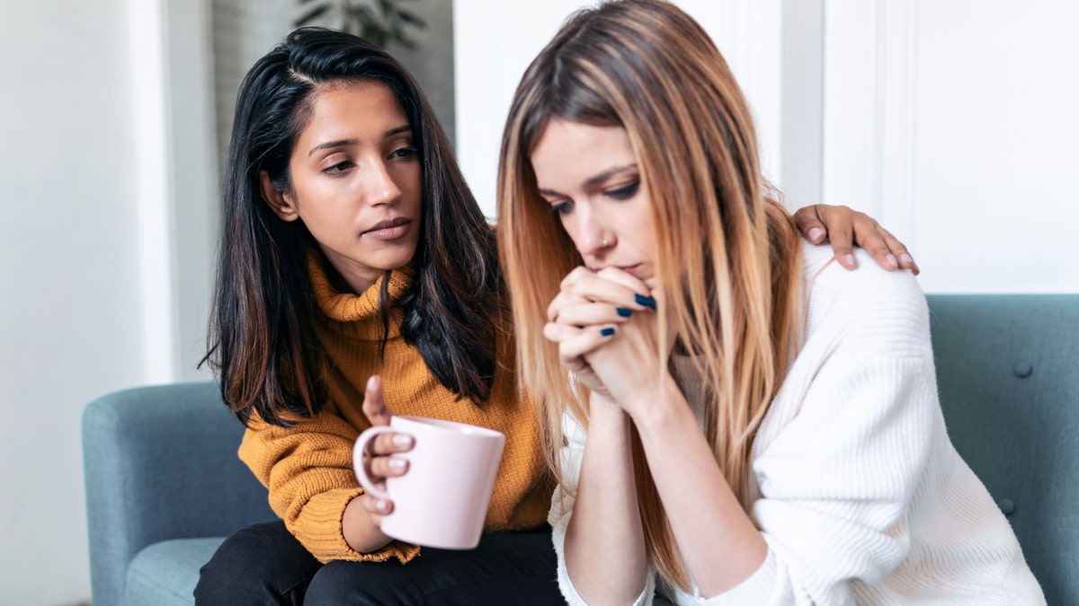 A female friend comforting another