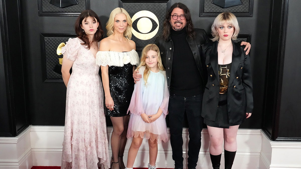 Foo Fighters star Dave Grohl hugs his daughters at the Grammys