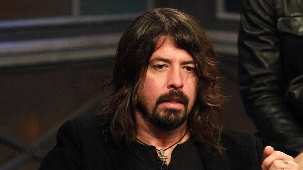 Foo Fighters singer Dave Grohl wears a black shirt