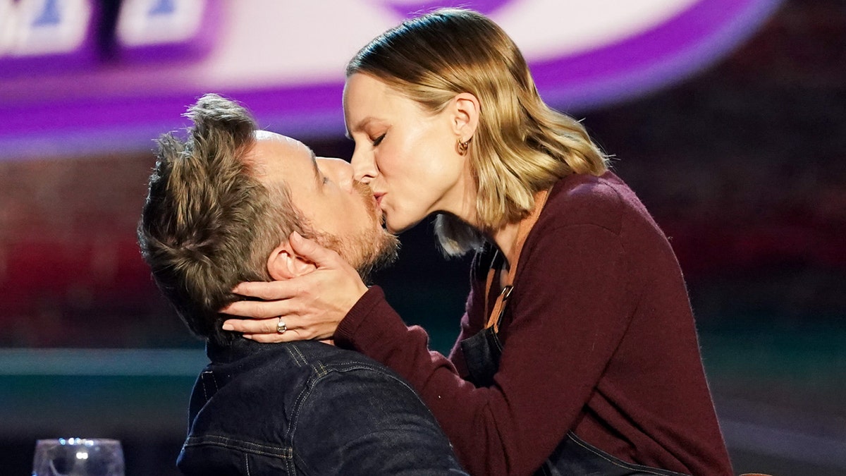 Dax Shepard and his wife Kristen Bell share a kiss on the set of 