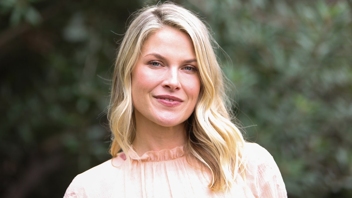 Ali Larter in a light pink blouse soft smiles for the camera