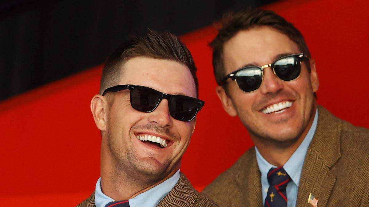 Bryson DeChambeau and Brooks Koepka smile