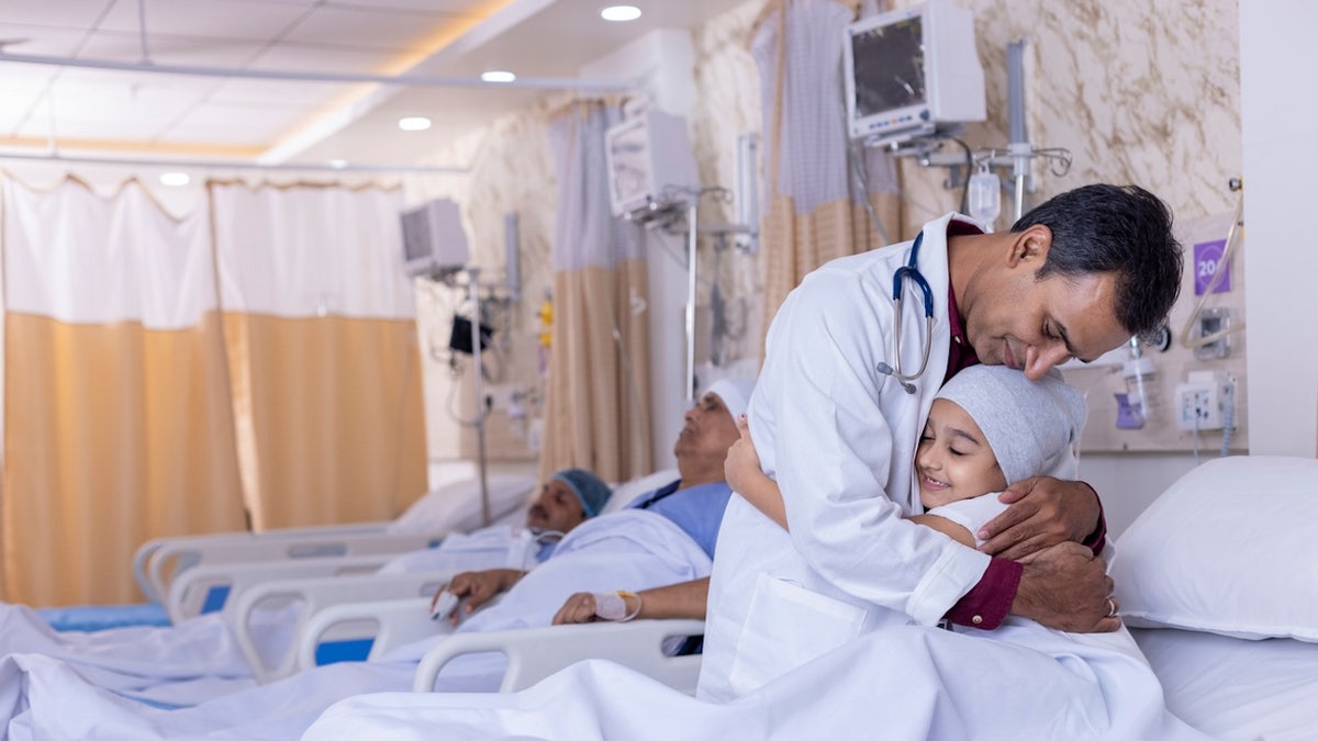 Doctor hugging child