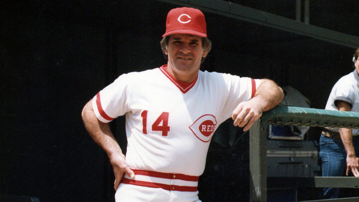 Pete Rose poses in the dugout