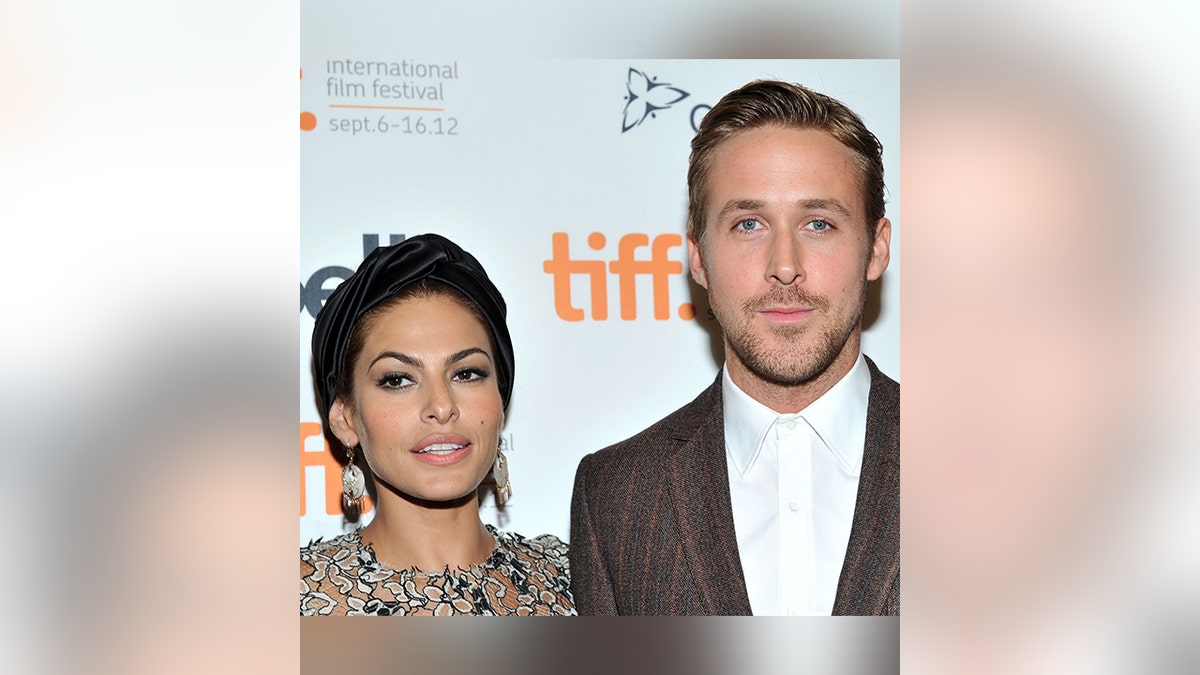 Eva Mendes and Ryan Gosling pose together on the carpet in Canada