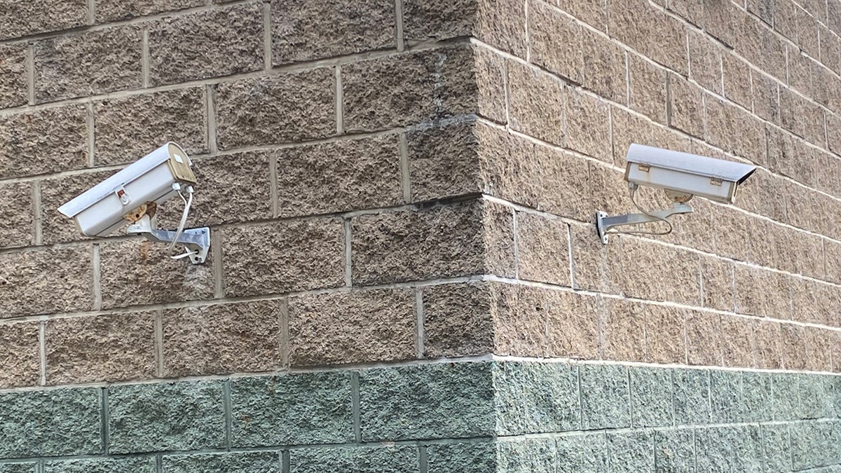 Two security cameras on corner of building