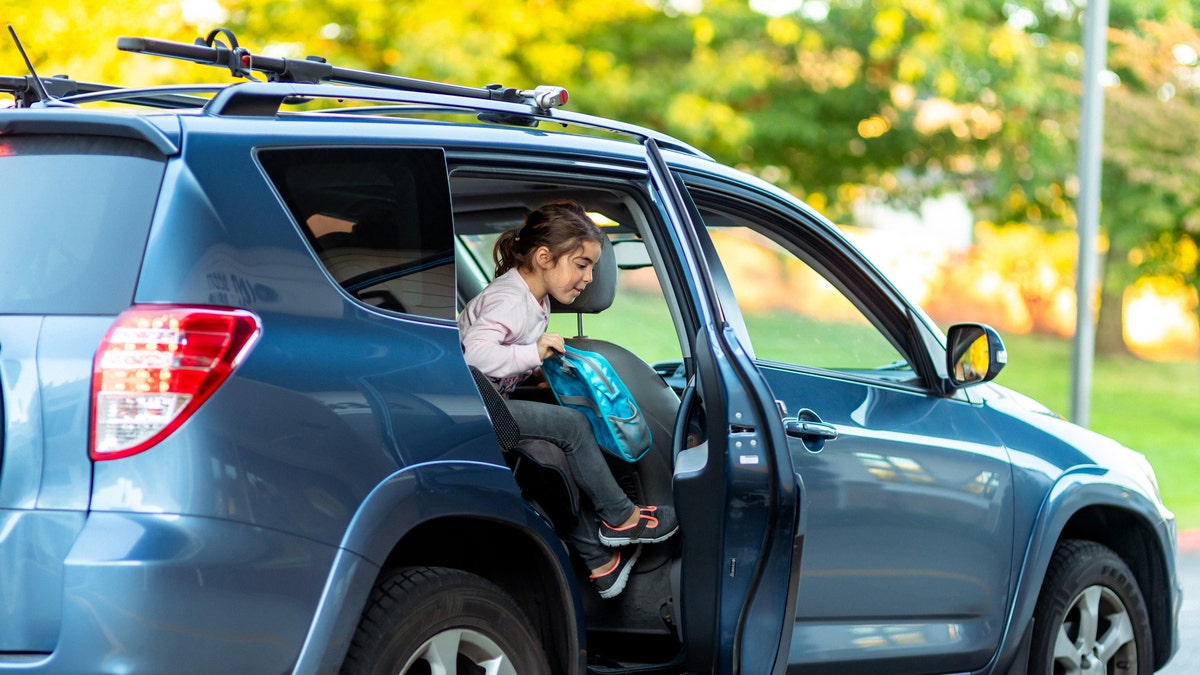 Young girl exiting the car