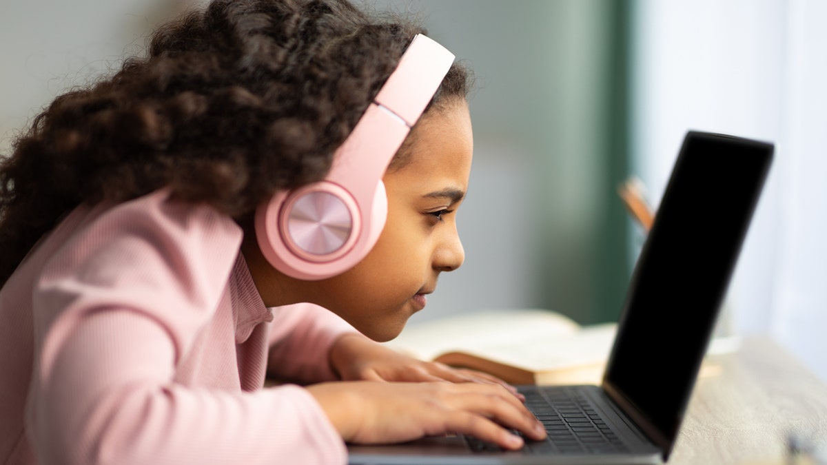 A girl looking at a screen